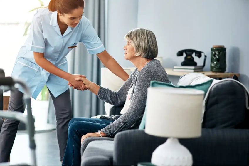 Nurse helping an elderly woman