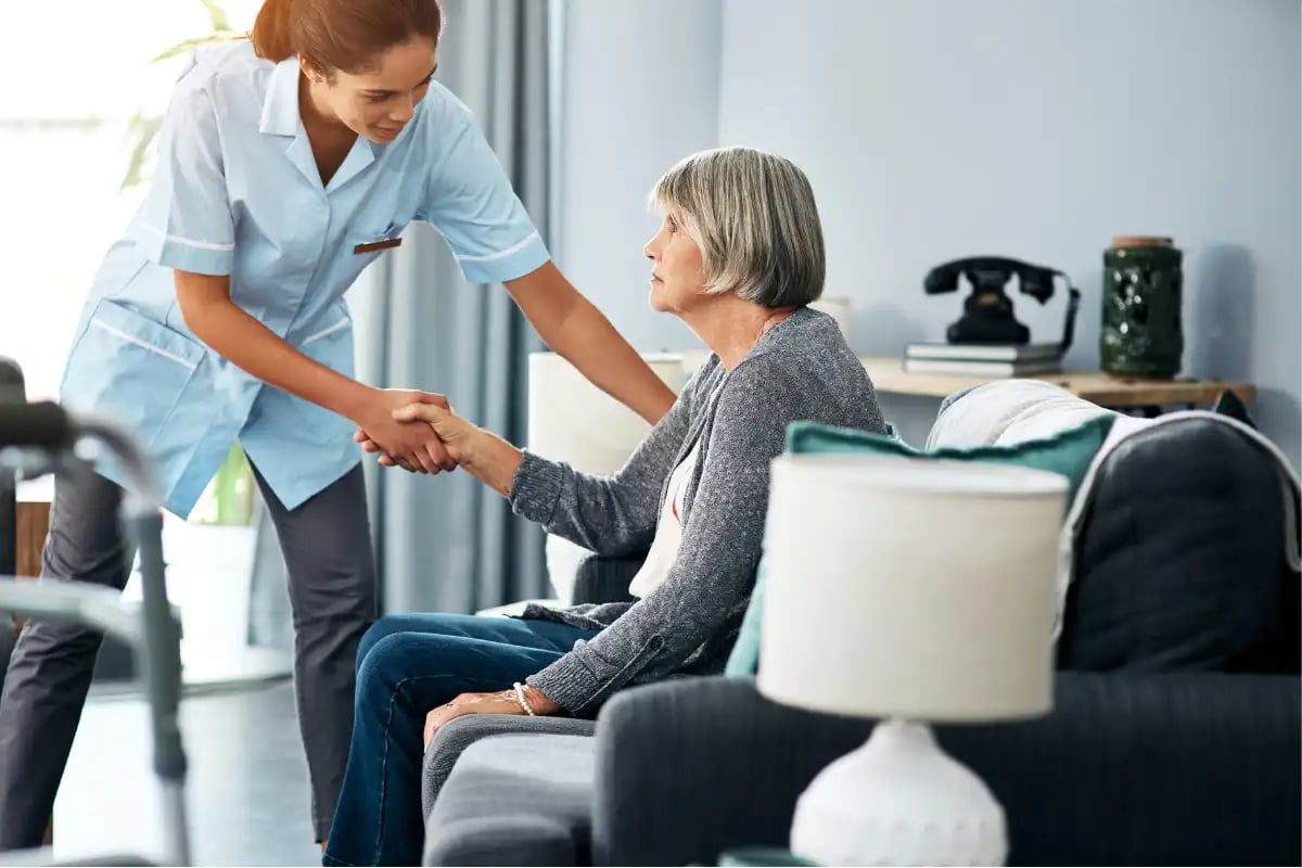 Nurse helping an elderly woman
