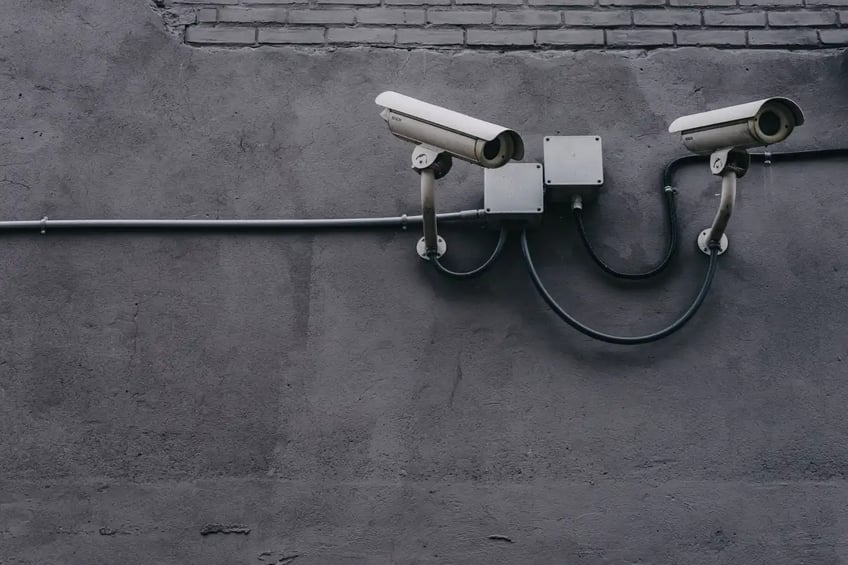 Two security cameras mounted on a wall
